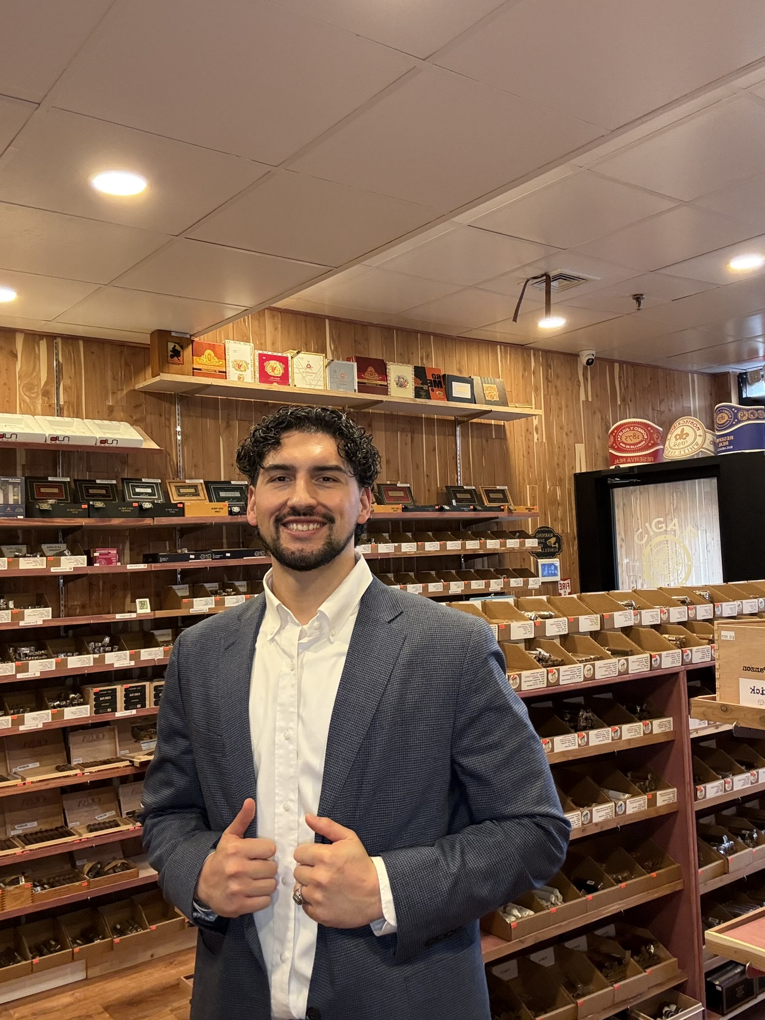Selim, owner of The Cigar Vault, standing in the store.